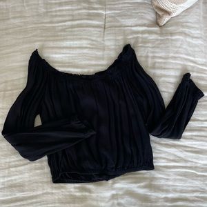 Off the shoulder black shirt.